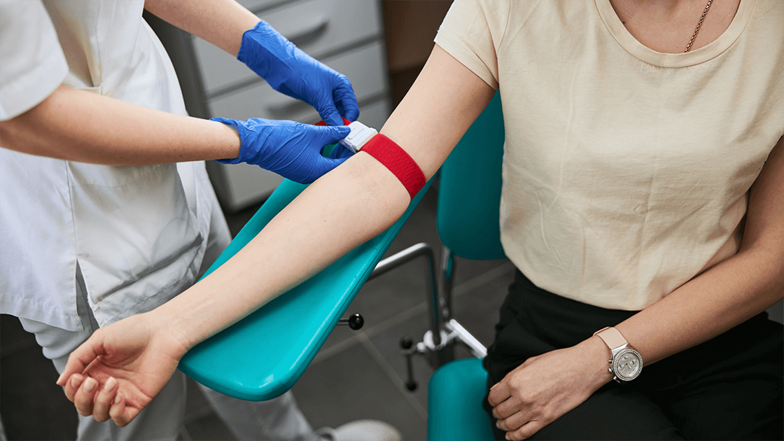 Maddox, a young phlebotomist, confidently drawing blood at a healthcare facility, symbolizing success in a rewarding career.